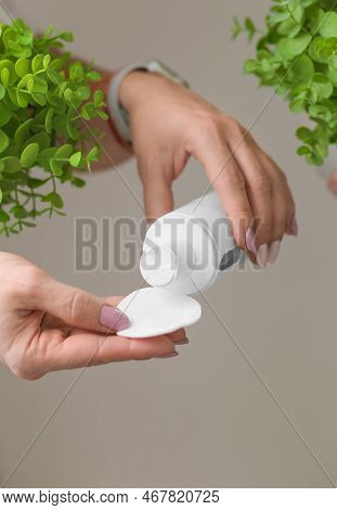 Cosmetics For Make-up Removal. Makeup Remover And Cotton Pad In Female Hands. A White Bottle With A 