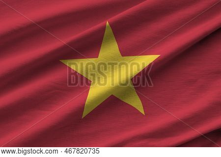 Vietnam Flag With Big Folds Waving Close Up Under The Studio Light Indoors. The Official Symbols And