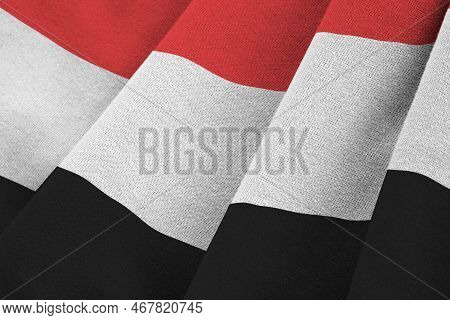 Yemen Flag With Big Folds Waving Close Up Under The Studio Light Indoors. The Official Symbols And C