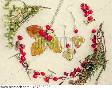 Close Up Bijouterie Made Of Epoxide Resin And Leaves Concept Photo. Top View Photography With Light 