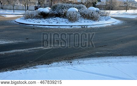 Roundabout Of Paving Gray Granite Cubes, Transport Hub, With Flowers And Grasses In The Middle Of Th
