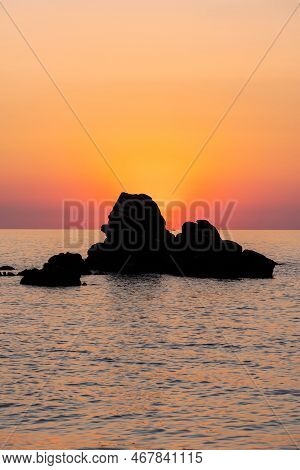 Beautiful View Of Orange Sunset Seascape With Rocks In Italy. Tropical Colourful Sunrise Landscape. 