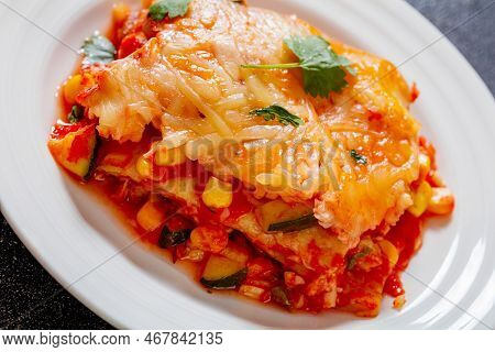 Close-up Of Vegetarian Enchilada Casserole Layered With Tortillas, Sauce, Pinto Beans, Corn, Zucchin