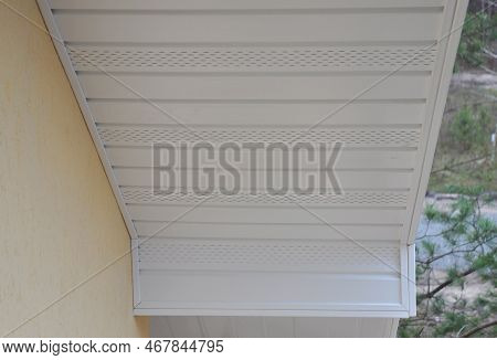 Plastic White Upvc Soffit Board Below The Facia Of The Roof.