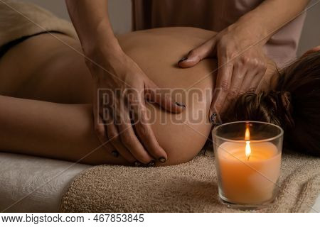 Close-up Of Women's Hands Doing Back Massage To A Girl Lying On A Massage Couch In A Massage Parlor 