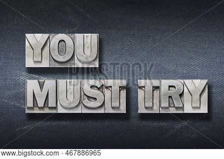 You Must Try Phrase Made From Metallic Letterpress On Dark Jeans Background