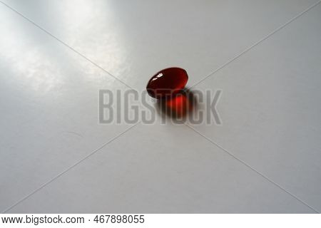 1 Red Softgel Capsule Of Krill Oil Dietary Supplement