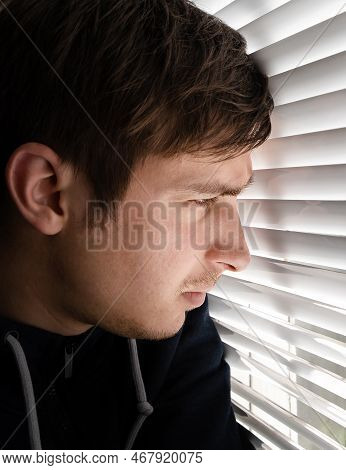 Man Is Spying Through The Jalousie In A Room Closeup