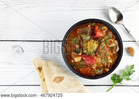 Khashlama Beef Or Lamb Meat With Vegetables And On A Wooden Background. Armenian And Georgian Cuisin