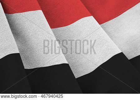 Yemen Flag With Big Folds Waving Close Up Under The Studio Light Indoors. The Official Symbols And C