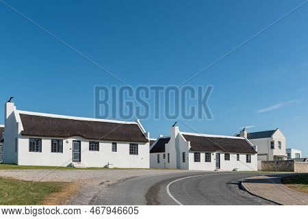 Arniston, South Africa - Sep 22, 2022: A Street Scene, With Thatched Roof Houses, In Arniston In The