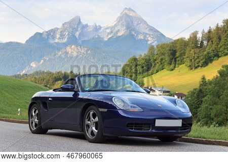 Berchtesgaden, Germany - July 25, 2021: Blue Roadster Porsche Boxster 986 With Mountain Watzmann And