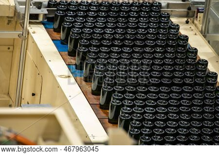 Production Of Cremant Sparkling Wine In Burgundy, France. Automatically Powered Bottling And Riddlin