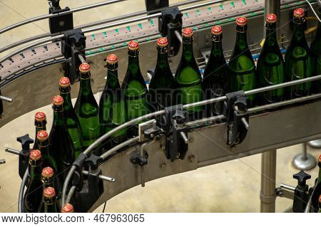 Production Of Cremant Sparkling Wine In Burgundy, France. Automatically Powered Bottling And Corking