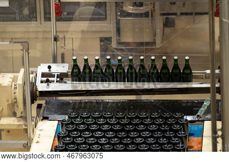 Production Of Cremant Sparkling Wine In Burgundy, France. Automatically Powered Bottling And Riddlin