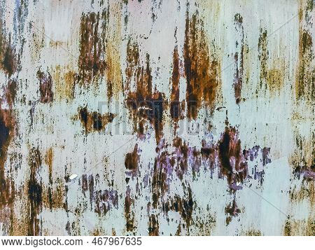 Close Up To Colored Peeling Paint Texture On Rusty Metal Surface. The Old Steel Wall, Painted And Pu