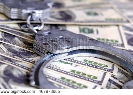 Cash In Us Dollars, Real Handcuffs. The Concept Of Arrest, Corruption, Bail, Crime, Bribery Or Fraud