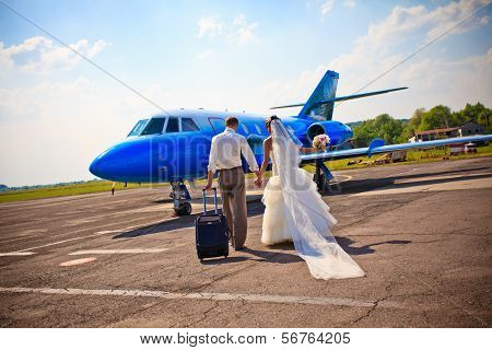 Wedding Couple Fly On Honeymoon