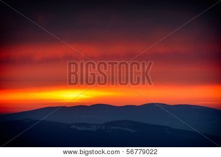 beautiful sunset over mountain peaks, Ceahlau, Romania