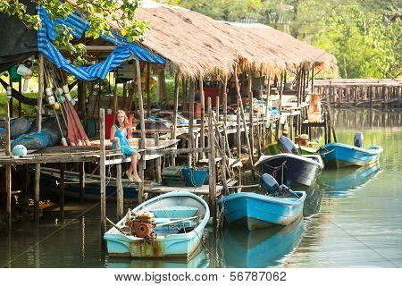 Teengirl in a fishing village (travel concept)