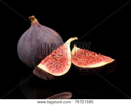 Quarters Of Figs Isolated On Black Background