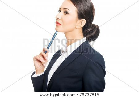 Portrait of businesswoman holding pen under chin.