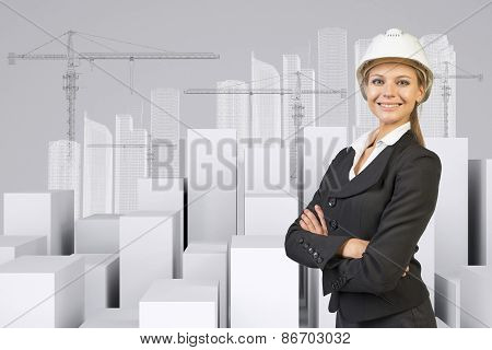 Woman with crossed arms. Cubes and wire-frame buildings