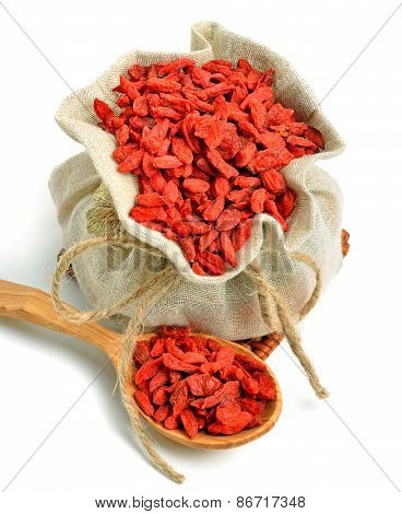 Goji Berries In The Sack Bag With Wooden Spoon Isolated