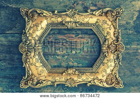 Vintage Baroque Golden Frame On Wooden Background. Grunge Texture