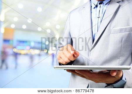 Handsome Young Man In Shopping Mall Using Mobile Tablet