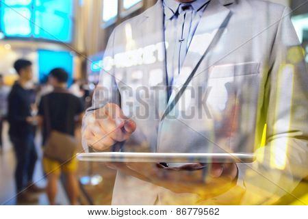 Double Exposure Manipulation Of Business Man Using Tablet And Blur Background Of Theatre E-ticket Sy