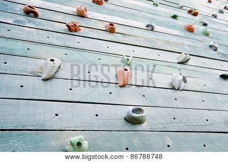 Grunge Surface Of An Artificial Rock Climbing Wall With Toe And Hand Hold Studs.