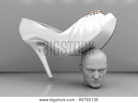 The man's head under a female heel on a gray background