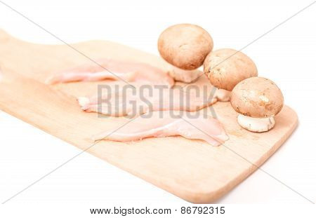 Sliced chicken breast with mushrooms for cooking