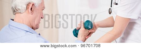 Elder Man Exercising With Dumbbell
