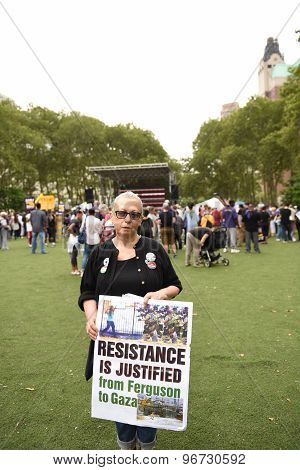Activist with sign in Cadman Plaza