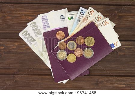 Passport and money on wooden table. Valid EURO banknotes, coins and banknotes Czech.