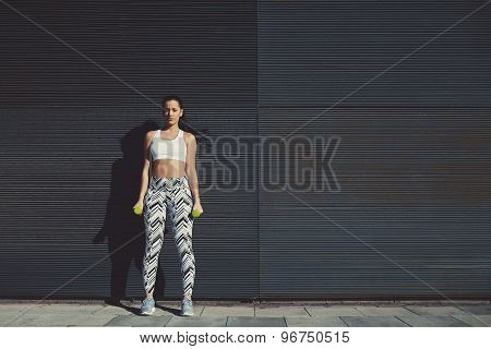 Female look to you while taking break during her training outdoors against black background