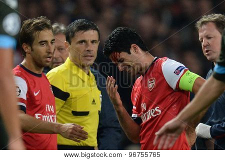 LONDON, ENGLAND - Oct 01 2013: Arsenal's midfielder Mikel Arteta from Spain sustains an injury during the UEFA Champions League match between Arsenal and Napoli.