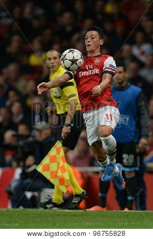 LONDON, ENGLAND - Oct 01 2013: Arsenal's midfielder Mesut Ozil from Germany controls the ball during the UEFA Champions League match between Arsenal and Napoli.