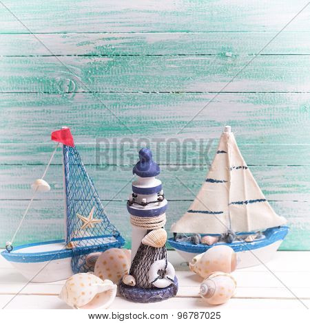 Decorative Lighthouse,  Sailing Boats And Marine Items On Wooden Background.