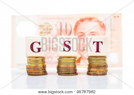 GST or Goods and Services Tax concept with stack of coins and Singapore Dollar currency as backdrop