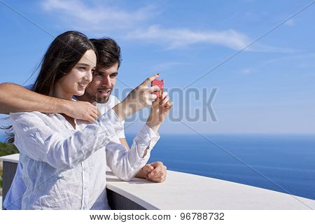 happy young couple taking selfie with cell phone