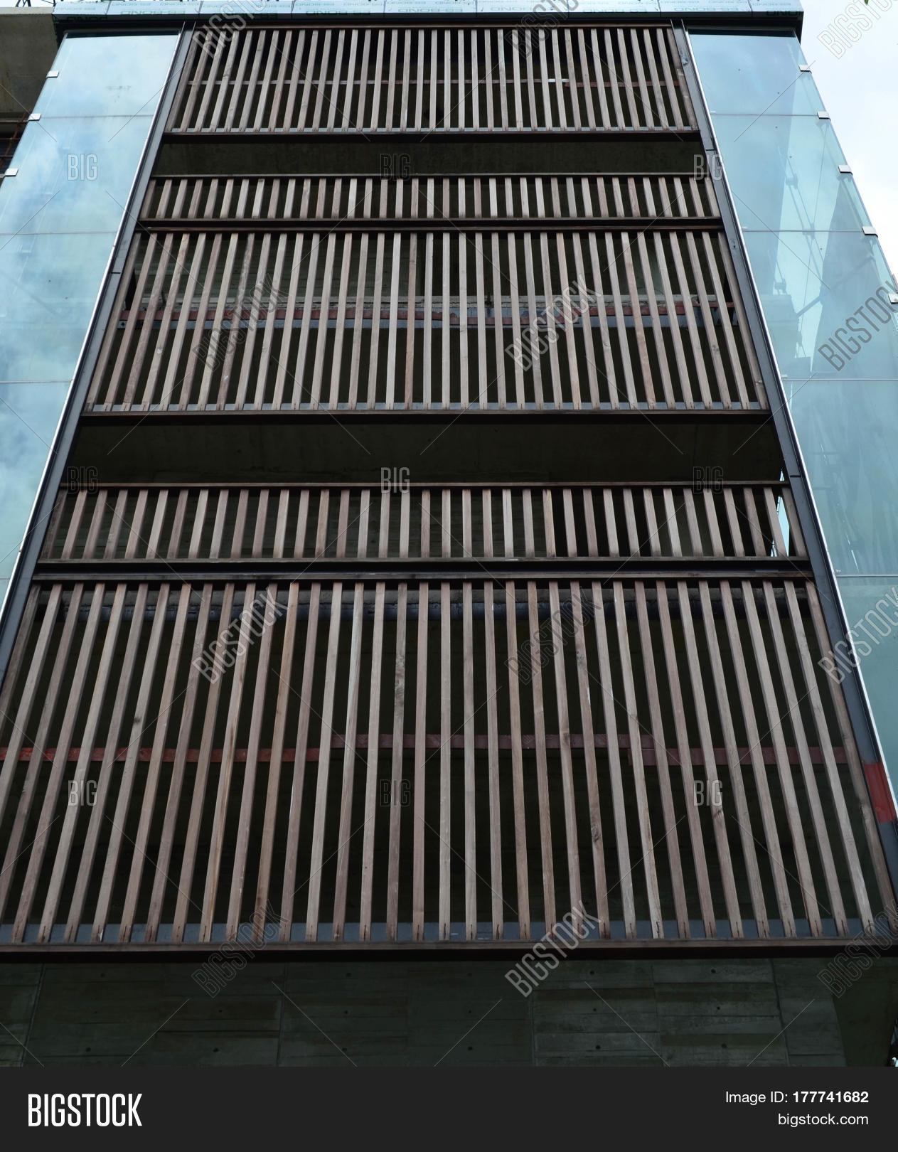 Wooden batten facade in front of modern building