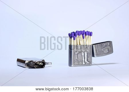 Many match sticks inside a lighter case isolated on white background