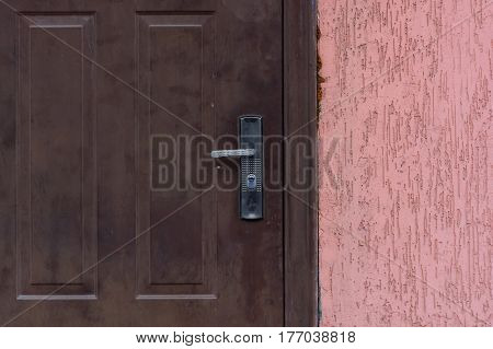 Closeup picture of dark front door with handle