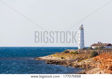 white lighthouse Hersones and road on the background of the sea in summer