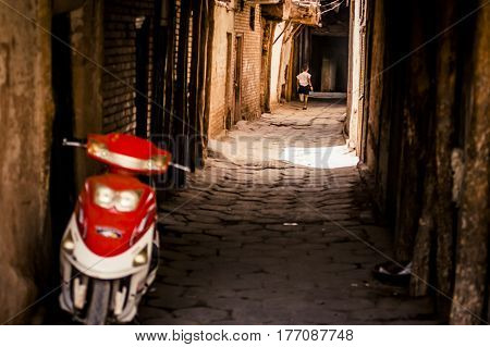 Child Running Through An Alley