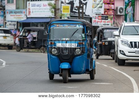 MIRISSA SRI LANKA - January 01 2017: Tuk-tuk moto taxi on the street. Famous thai moto-taxi called tuk-tuk is a landmark of the country and popular transport.