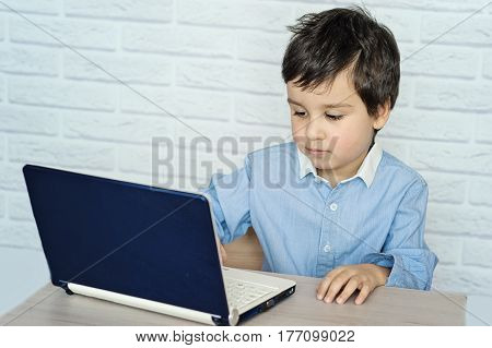 Concept of little businessman webmaster programmer developer Website designer. Little child and laptop computer notebook